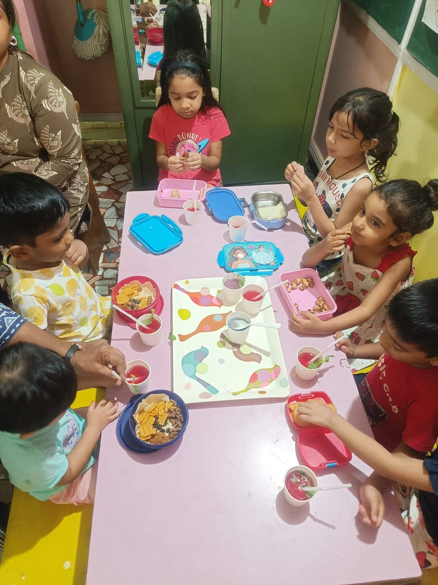 Children working together at an outdoor art activity table